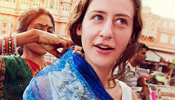 Female tourist trying on saree in market in Jaipur, India